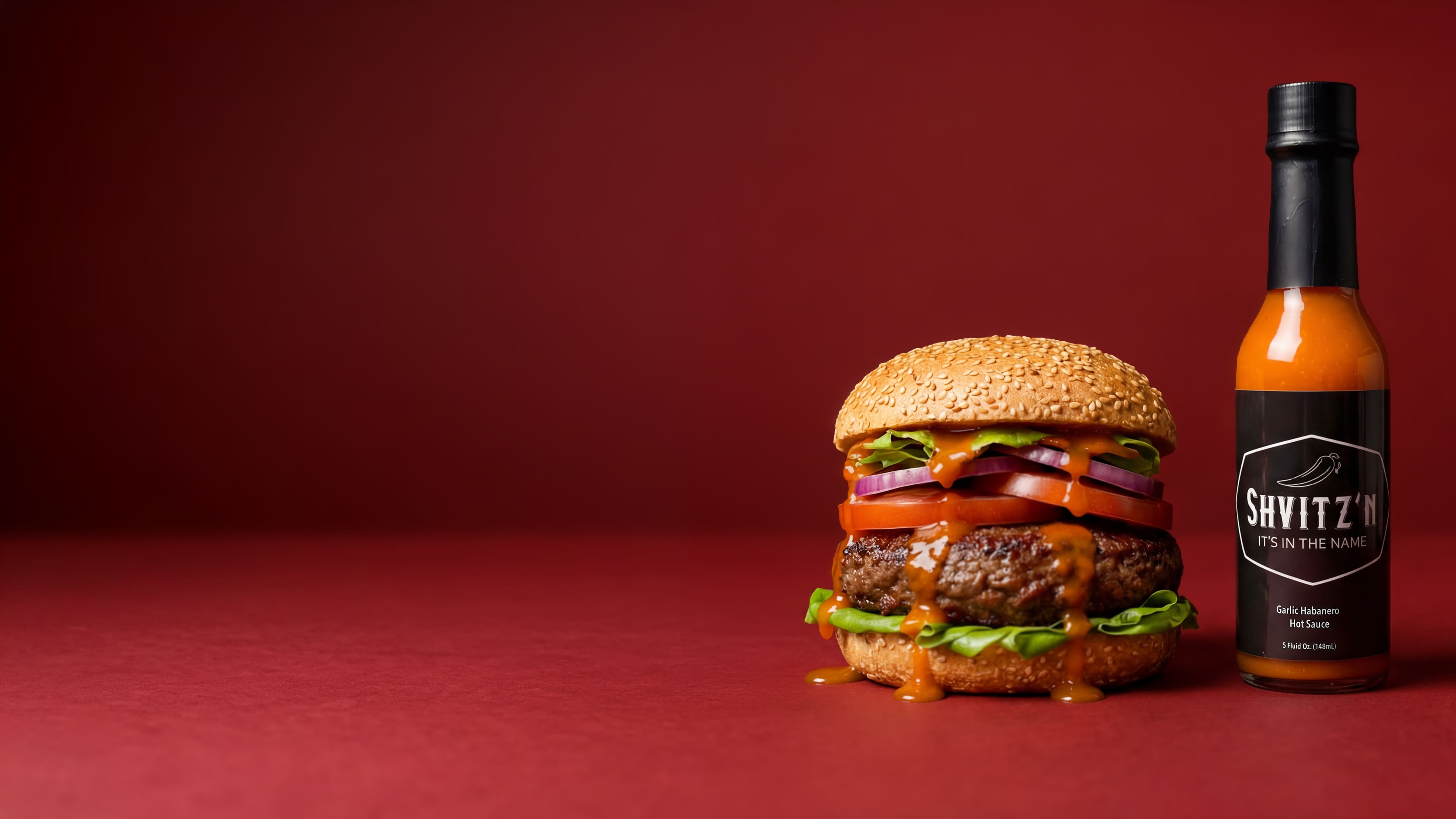 Shvitzn Garlic Habanero Hot Sauce Bottle with a juicy burger. Bold, OU-certified kosher flavor that goes on everything!